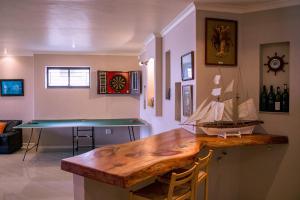 a kitchen with a wooden counter with a model boat on it at Welsh Whales - Pet Friendly - Seafront Retreat in De Kelders