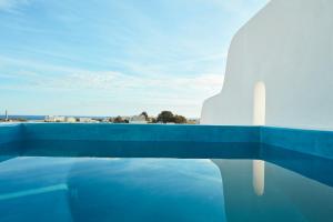 a swimming pool with a view of the city at Orabel Suites Santorini (Adults Only) in Perivolos
