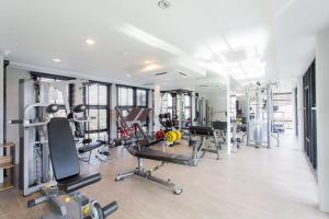 a gym with several treadmills and machines at Condo Surin-Bangtao Beach in Ban Lum Fuang