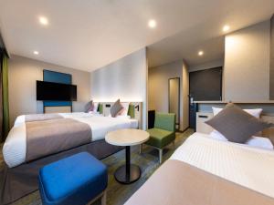 Ένα ή περισσότερα κρεβάτια σε δωμάτιο στο HOTEL MYSTAYS Miyazaki
