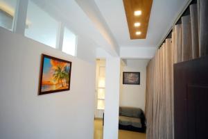 a room with a bed and a wall with a picture at Hr residency in Kozhikode