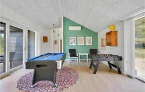 a room with a pool table and a table at 4 Bedroom Amazing Home In Blokhus in Blokhus +18 photos