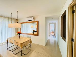 a dining room with a table and chairs and a mirror at Soha Homestay in Kuala Lumpur