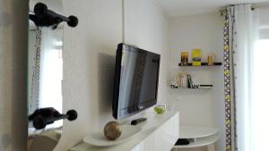 a television on a wall in a room at Cozy studio with balcony and free secure parking in Pau