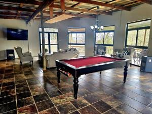 a living room with a pool table in it at Misty River in Lions River
