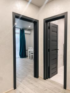 an open door in a room with a table at Apartments Domovik Стильна квартира, Миру 11 c кв 2 in Mukacheve