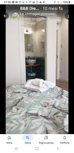 a poster of a bedroom with a bed and a sink at B&B DieMme Amalfi Coast in Vietri sul Mare