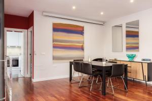 a dining room with a table and chairs and a painting at Dream Vacation at Casa Vicki in Almería