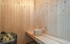 a sauna with a bucket on a wooden table at Holiday Home Knebel 26 in Knebel