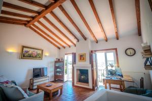 a living room with a couch and a fireplace at Casa da Alba in Alentejo in Melides