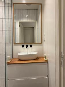 a bathroom with a white sink and a mirror at Luxury Suite - Amsterdam Lounge in Amsterdam