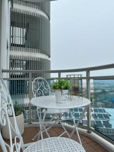 a white table and chairs on a balcony at The Bahamas & Maldives Suites at Azure Residences near Manila Airport in Manila