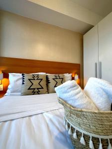 a bedroom with a bed with white sheets and pillows at The Bahamas & Maldives Suites at Azure Residences near Manila Airport in Manila