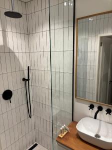 a bathroom with a sink and a shower with a mirror at Luxury Suite - Amsterdam Lounge in Amsterdam