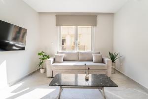 a living room with a couch and a coffee table at Luna Luxury Suite - close to Acropolis in Athens