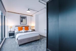 a bedroom with two beds with orange pillows at Comfort and Style 1Bed Apartment in Warrington in Warrington +29 photos