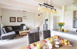 a kitchen and living room with a table and chairs at Nice Home In Dagebüll With Sauna in Dagebüll +15 photos