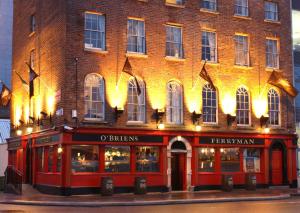 a red brick building with a restaurant in front of it at The Ferryman Townhouse in Dublin