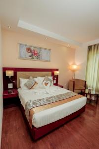 Postel nebo postele na pokoji v ubytování Bravura Gold Resort