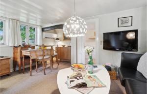 a living room with a couch and a table at 3 Bedroom Gorgeous Home In Nexø in Neksø