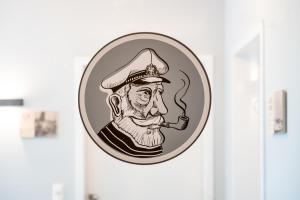 a sticker of a man with a pipe in his mouth at 4Hafenzeiten - NIE13 Eva in Niendorf