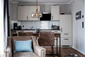a living room with a couch and a table with a blue pillow at 4Hafenzeiten - NIE1 Lucie in Niendorf +9 photos