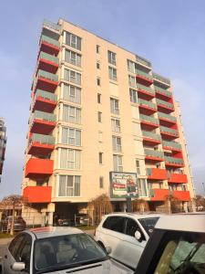 a tall building with cars parked in front of it at Home Guest - Apartment 1 in Oradea