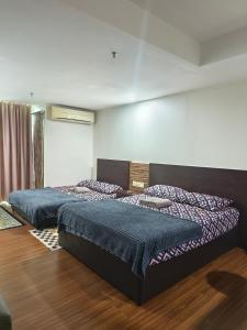 Ένα ή περισσότερα κρεβάτια σε δωμάτιο στο AZH Studio KBCP Bandar Kota Bharu +1 φωτογραφίες