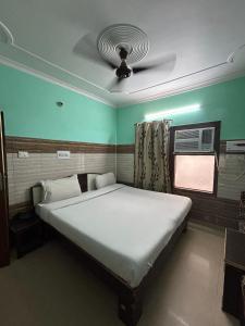 a bedroom with a large bed with a ceiling at BK plaza in Chandīgarh
