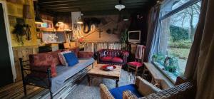 a living room with a couch and a table at Villa Berk en Heide in Rosmalen