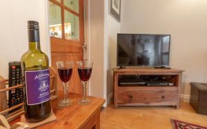 a bottle of wine and two glasses on a table at Wheelhouse in Southwold +10 photos