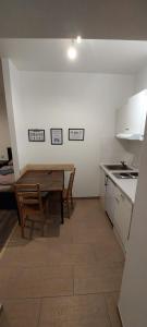 a small kitchen with a wooden table and a tableasteryasteryasteryasteryasteryastery at Monteurwohnungen in Wanzleben in Wanzleben