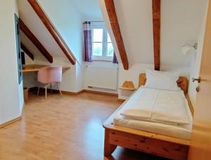 a small bedroom with a bed and a window at Oberamer Hof in Bad Saulgau +44 photos