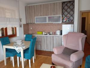 a kitchen with a table and a chair and a dining room at Mio Lux in Baošići