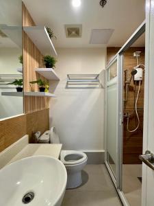 a bathroom with a toilet and a sink at Asters - Two Bedroom Condo Unit with Balcony in Davao City