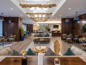 a lobby of a hotel with a couch and a table at Novotel Makkah Thakher City in Makkah