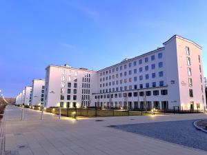 a row of large white buildings at night at Haus Arkona - Apartment Seestern - 5 2 in Prora
