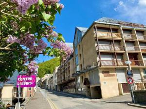 a city street with a building with a purple sign at Studio Bareges in Barèges