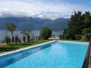 a swimming pool with a view of a lake and mountains at Cordelia 9 Apartment in Luino