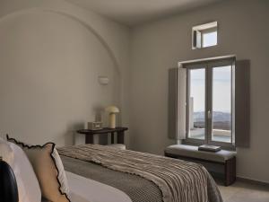 a bedroom with a bed and a window at Ark in Pirgos
