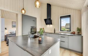 a kitchen with a large island in a room at Nice Home In Hvide Sande With Sauna in Bjerregård