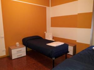 a bedroom with a bed and a laptop on a table at Appartamento 2 -NEW in Cossirano