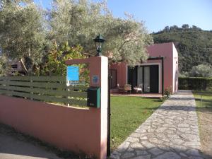 a sign on a fence next to a house at Ionian Breeze Studios in Lefkada Town