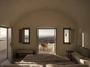 a bedroom with a bed and a view of a balcony at Ark in Pirgos