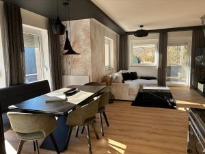 a kitchen and living room with a table and chairs at Messners Ferienhaus in Löllinggraben