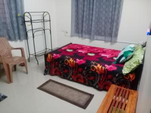 a bedroom with a bed and a chair at Little Mount nest in Trivandrum