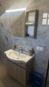 a bathroom with a sink and a mirror at Studio Greek Mansion in Nea Moudania +9 photos