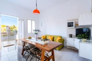 una sala de estar con una mesa y un sofá en Appartamento La Meta by BarbarHouse, en Sant'Isidoro 20 fotos más