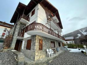 a building with a balcony on top of it at Artemisia in Bardonecchia
