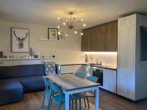 a kitchen and living room with a table and a couch at Artemisia in Bardonecchia